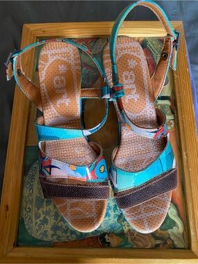 The Art Company, featuring a turquoise and multi-colored abstract pattern